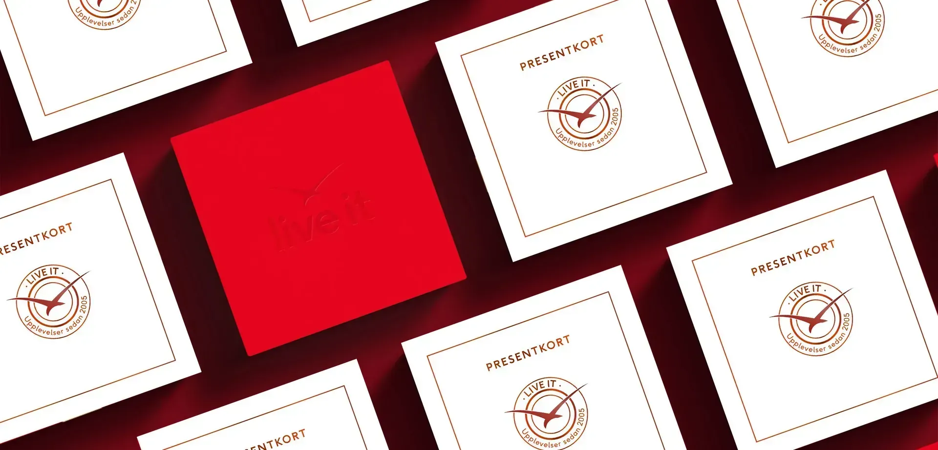 Red and white "Live it" gift cards with logo, arranged on a red background