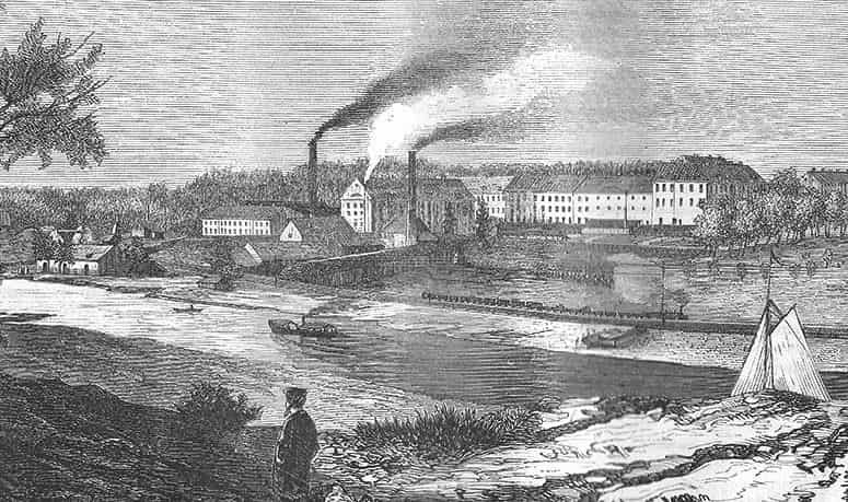 Etsning: Vattendrag med byggnader, skorstenar med rök och en person. Segel på stranden